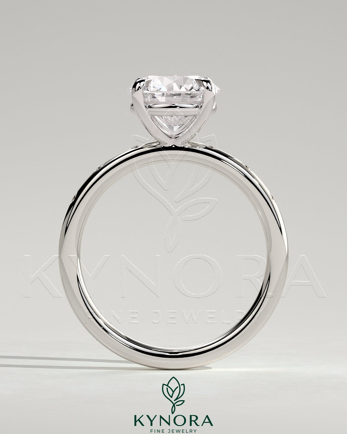 Kynora CJ 2ct round claw solitaire engagement ring with inset round accent stones, showcasing a elegant and sparkling design.