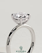Kynora CJ 2ct round claw solitaire engagement ring with inset round accent stones, elegant and sparkling jewelry piece.