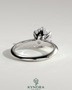 Kynora CJ 2ct round diamond claw solitaire engagement ring with a sleek knife edge band, showcasing elegant jewelry design.