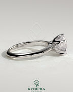 Kynora CJ 2ct round claw solitaire engagement ring with knife edge band, showcasing a sparkling central diamond in elegant jewelry design.