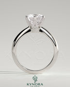 Kynora CJ 2ct round claw solitaire engagement ring with a knife edge band, showcasing a sparkling center diamond and elegant design.