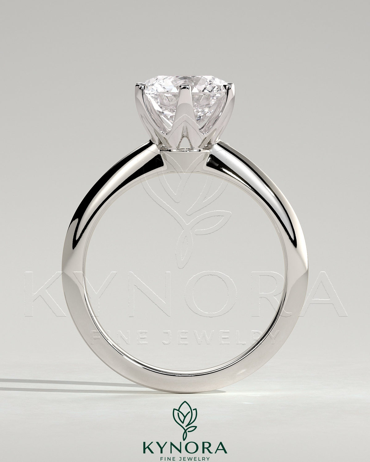 Kynora CJ 2ct round claw solitaire engagement ring with a knife edge band, showcasing a sparkling center diamond and elegant design.
