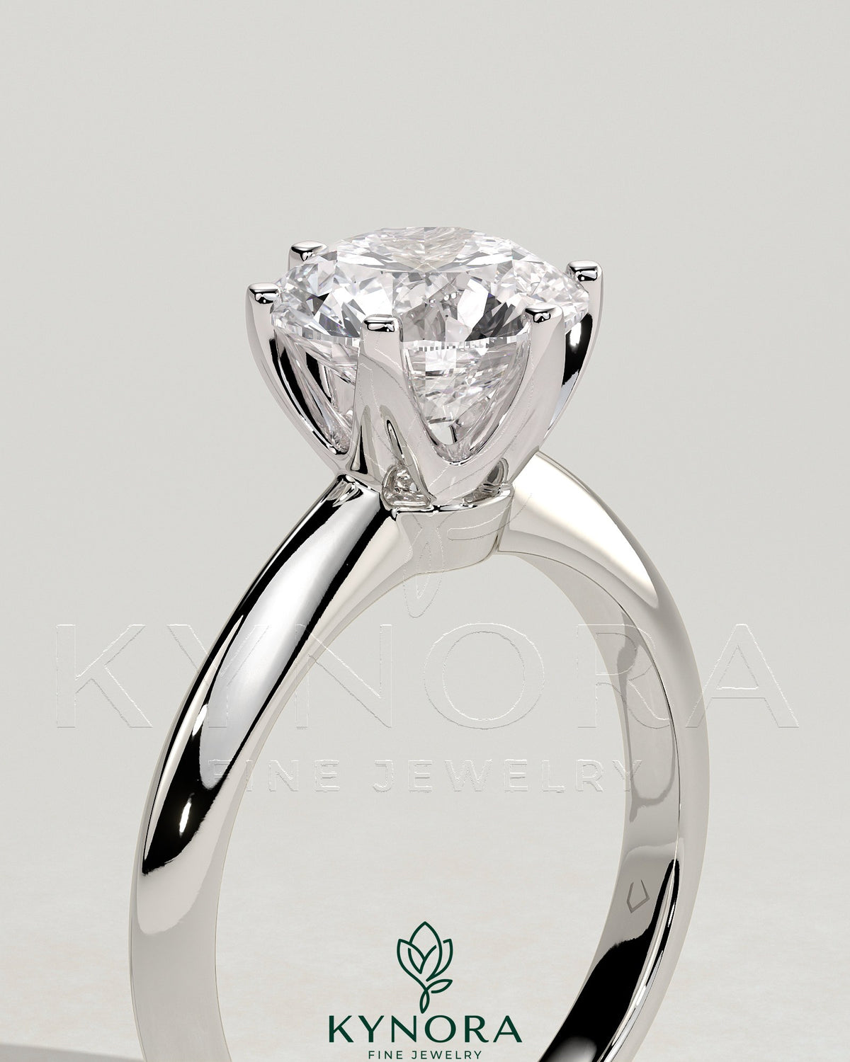 Kynora CJ 2ct round claw solitaire engagement ring with knife edge band, showcasing a sparkling center diamond and elegant design.