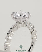 Kynora CJ 2ct round claw solitaire engagement ring with marquise and round accent stones, showcasing elegant jewelry design.