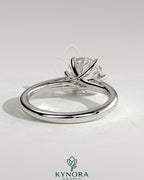 Kynora CJ 2ct round claw solitaire engagement ring with open trellis gallery and cathedral low setting, showcasing elegant jewelry design.