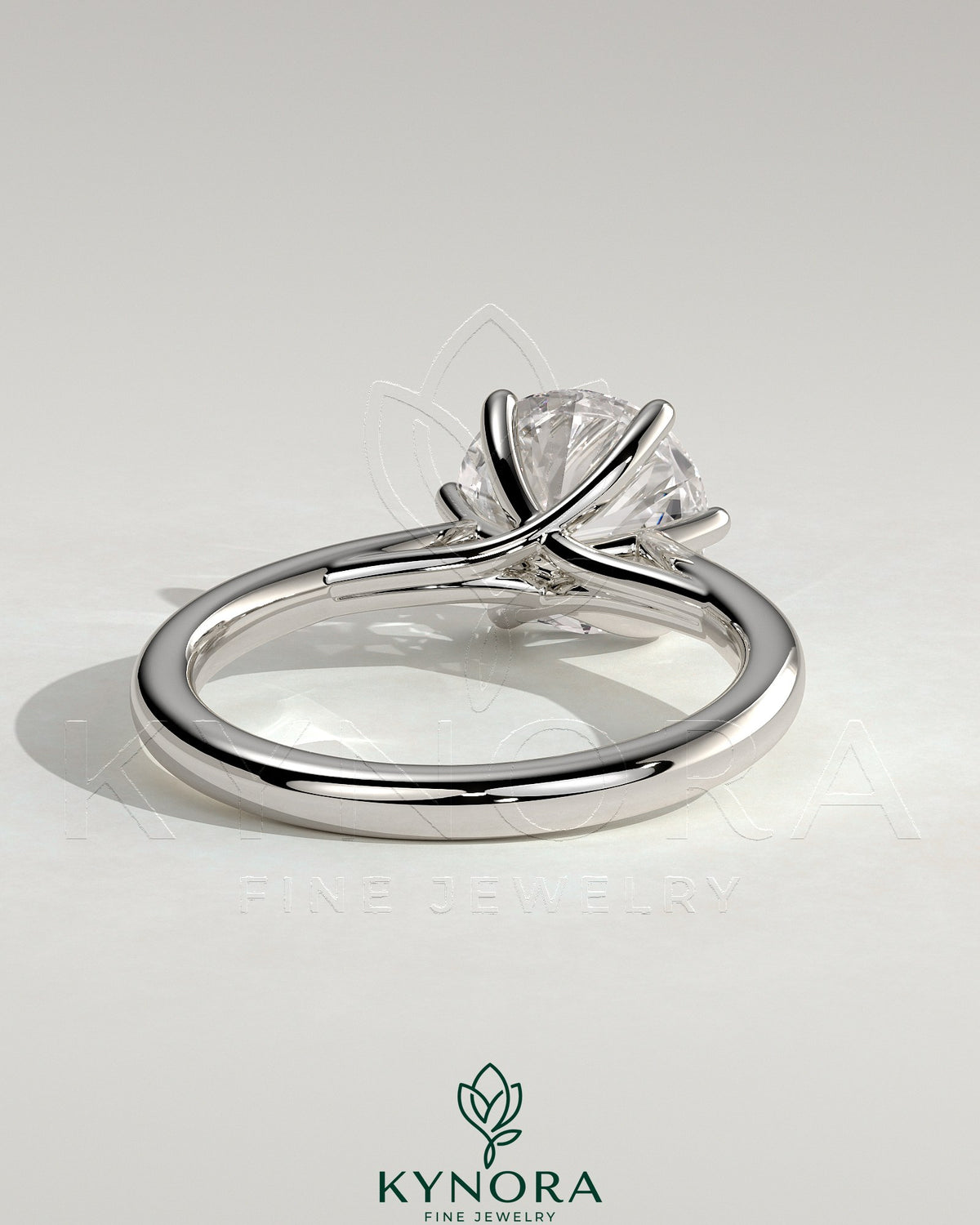 Kynora CJ 2ct round claw solitaire engagement ring with open trellis gallery and cathedral low setting, showcasing elegant jewelry design.