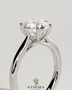 Kynora CJ 2ct round claw solitaire engagement ring with open trellis gallery and cathedral low setting, showcasing elegant diamond design.