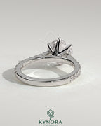 Kynora CJ 2ct round claw solitaire engagement ring with pave band and cathedral high setting, showcasing elegant diamond design.