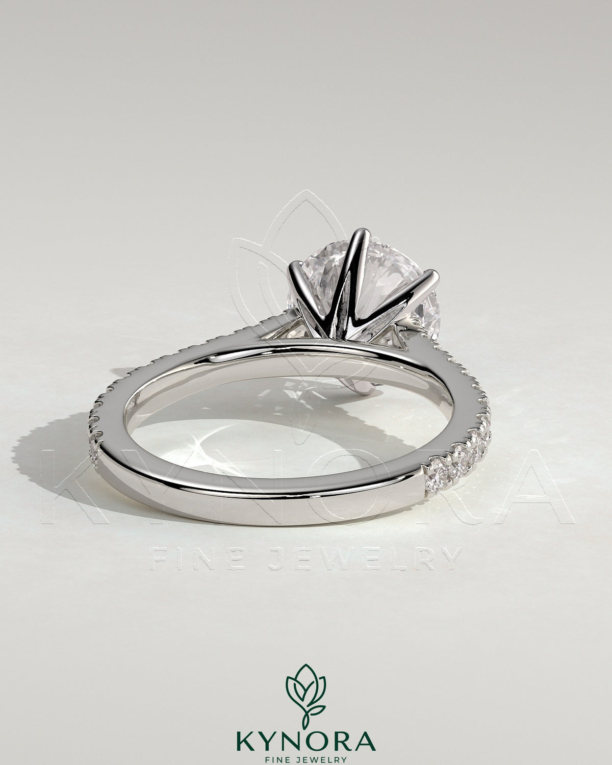 Kynora CJ 2ct round claw solitaire engagement ring with pave band and cathedral high setting, showcasing elegant diamond design.