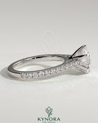Kynora CJ 2ct round diamond claw solitaire engagement ring with pave band and cathedral high setting, elegant and sparkling.