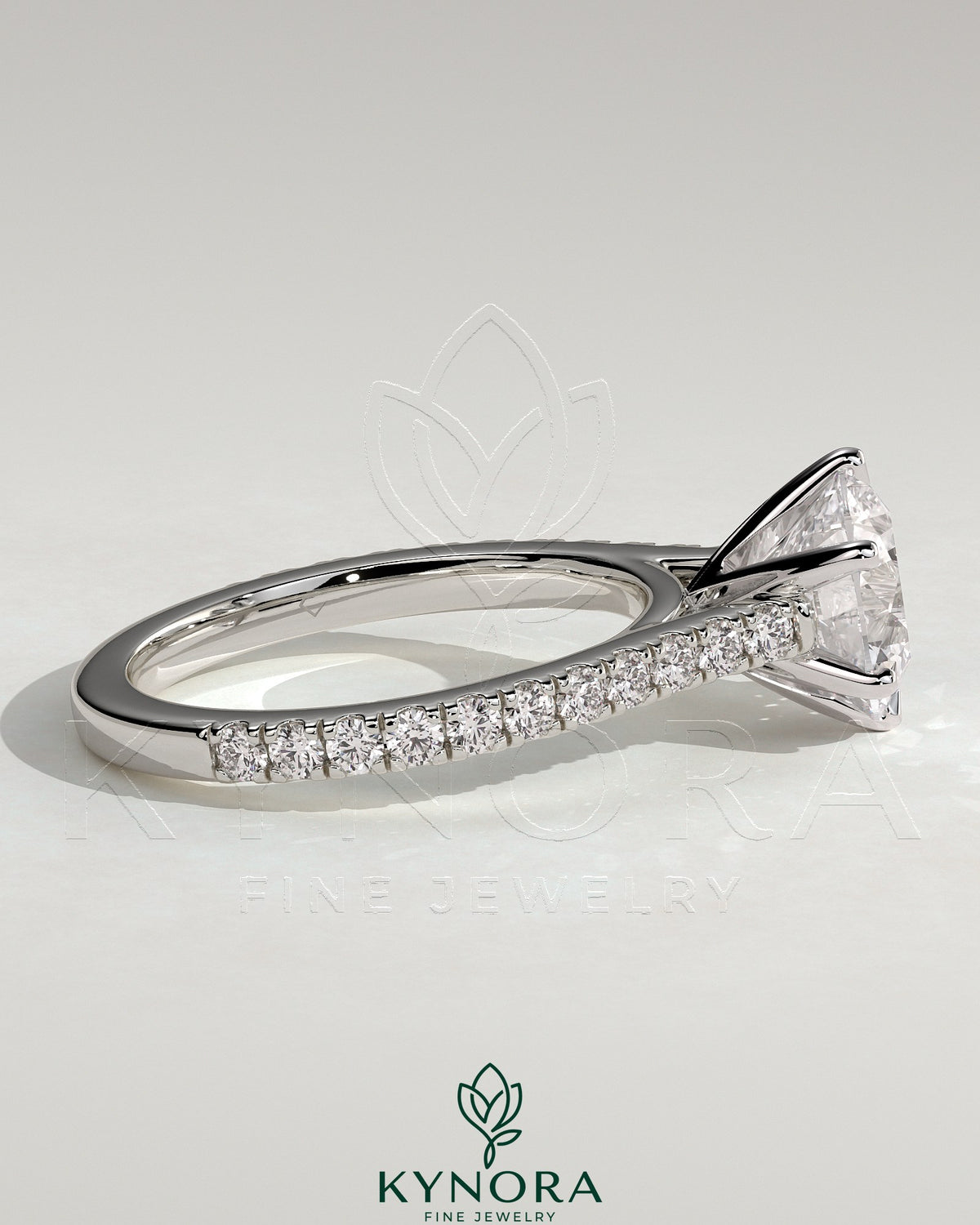 Kynora CJ 2ct round diamond claw solitaire engagement ring with pave band and cathedral high setting, elegant and sparkling.