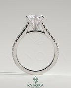 Kynora CJ 2ct round diamond claw solitaire engagement ring with pave band and cathedral high setting, elegant and sparkling.