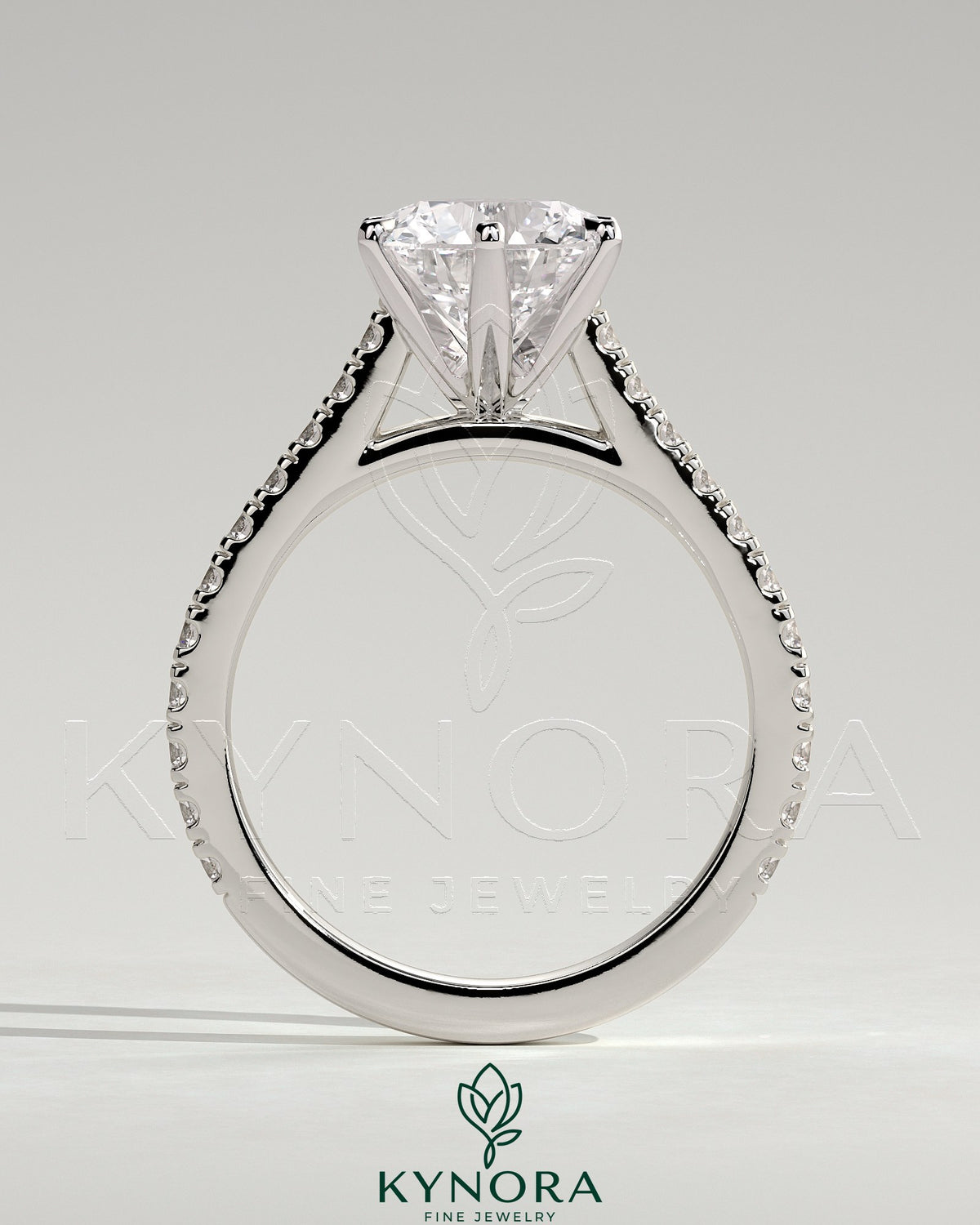 Kynora CJ 2ct round diamond claw solitaire engagement ring with pave band and cathedral high setting, elegant and sparkling.