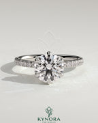 Kynora CJ 2ct round diamond claw solitaire engagement ring with pave band and pave collar in elegant jewelry setting