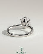 Kynora CJ 2ct round claw solitaire engagement ring with pave band and pave collar, showcasing sparkling diamond details.