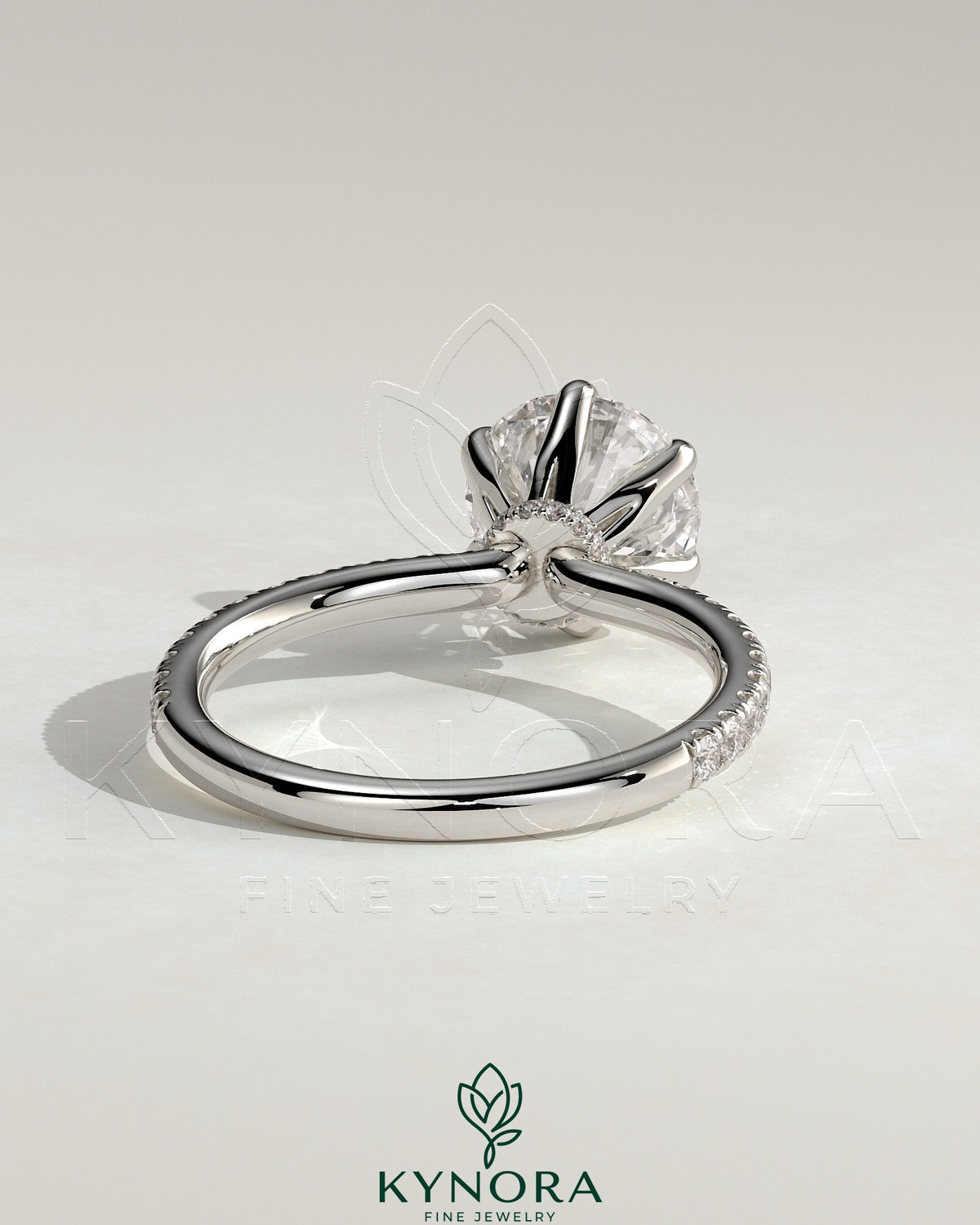 Kynora CJ 2ct round claw solitaire engagement ring with pave band and pave collar, showcasing sparkling diamond details.
