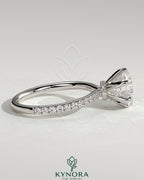 Kynora CJ 2ct round claw solitaire engagement ring with pave band and pave collar, showcasing elegant diamond setting.