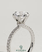 Kynora CJ 2ct round diamond solitaire engagement ring with pave band and collar setting, showcasing elegant craftsmanship and sparkle.