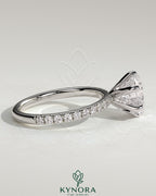 Kynora CJ 2ct round diamond claw solitaire engagement ring with pave band, showcasing elegant craftsmanship and sparkling design.