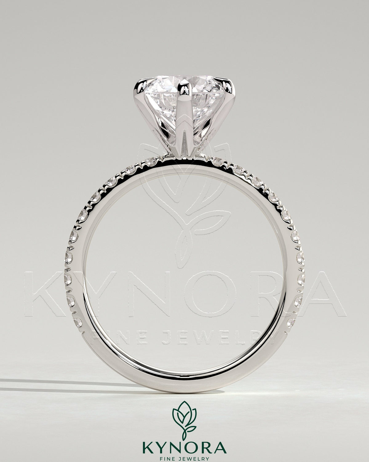 Kynora CJ 2ct round diamond claw solitaire engagement ring with pave band, showcasing elegant design and sparkling gemstones.