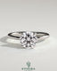 Kynora CJ 2ct round claw solitaire engagement ring with petal gallery, leaf accents, and cathedral setting, showcasing fine jewelry craftsmanship.