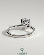 Kynora CJ 2ct round claw solitaire engagement ring with petal gallery, leaf accents, and cathedral setting.