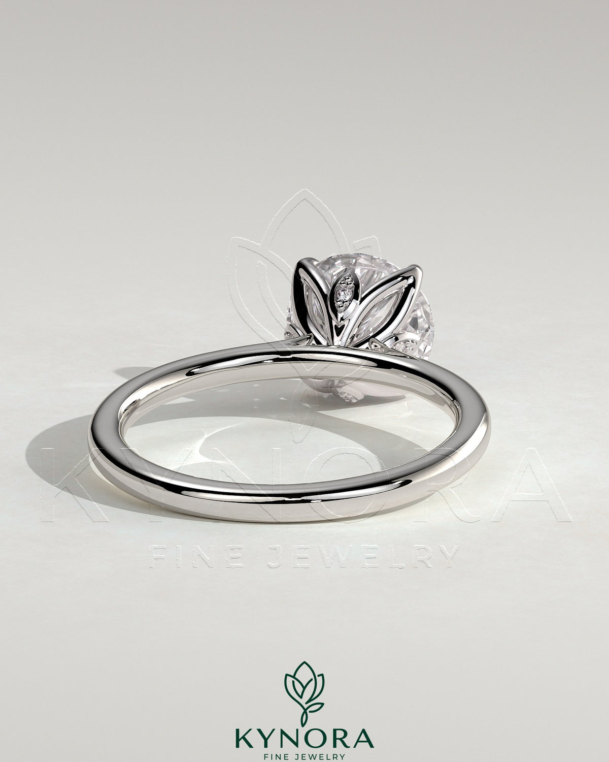 Kynora CJ 2ct round claw solitaire engagement ring with petal gallery, leaf accents, and cathedral setting.