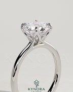 Kynora CJ 2ct round claw solitaire engagement ring with petal gallery, leaf accents, and cathedral setting in silver.