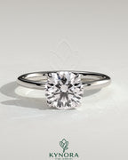 Kynora CJ 2ct round claw solitaire engagement ring with petal gallery and leaf accents, showcasing elegant jewelry design.