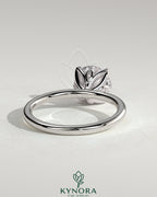 Kynora CJ 2ct round claw solitaire engagement ring with petal gallery and accent leaf details, showcasing intricate design and sparkling diamond