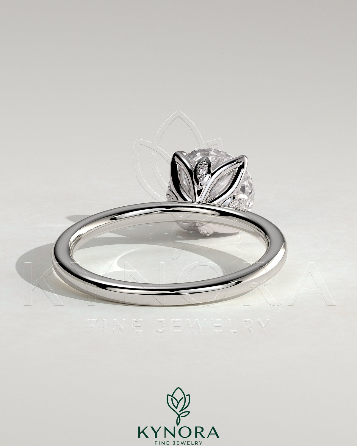 Kynora CJ 2ct round claw solitaire engagement ring with petal gallery and accent leaf details, showcasing intricate design and sparkling diamond