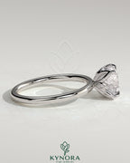 Kynora CJ 2ct round claw solitaire engagement ring with petal gallery and accent leaf details, showcasing elegant jewelry design.