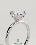 Kynora CJ 2ct round claw solitaire engagement ring with petal gallery and accent leaf details, showcasing elegant jewelry design.