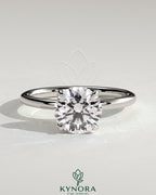 Kynora CJ 2ct round claw solitaire engagement ring with petal gallery and accented tiara detail, showcasing intricate design.
