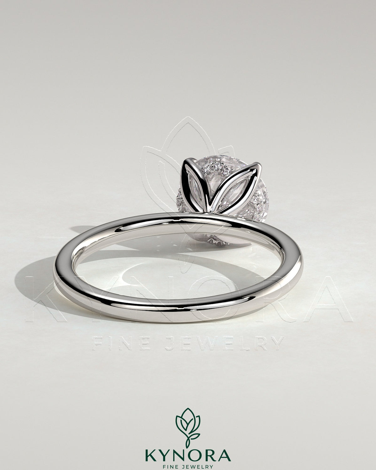 Kynora CJ 2ct round claw solitaire engagement ring with petal gallery and accented tiara detail, showcasing intricate design and sparkling diamond.