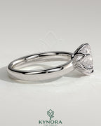 Kynora CJ 2ct round claw solitaire engagement ring with petal gallery and cigar band design in silver or white gold.