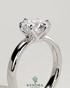 Kynora CJ 2ct round claw solitaire engagement ring with petal gallery and cigar band design, showcasing a sparkling diamond.