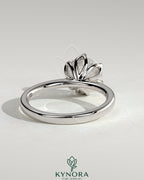 Kynora CJ 2ct round claw solitaire engagement ring with petal gallery and tapered band showcasing elegant jewelry design.