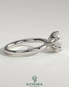 Kynora CJ 2ct round claw solitaire engagement ring with petal gallery detail and tapered band, elegant and sparkling jewelry piece.