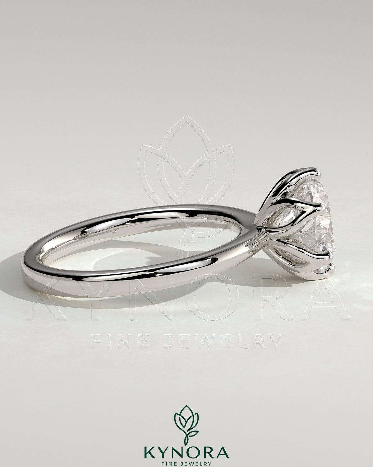 Kynora CJ 2ct round claw solitaire engagement ring with petal gallery detail and tapered band, elegant and sparkling jewelry piece.