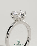 Kynora CJ 2ct round claw solitaire engagement ring with petal gallery design and tapered band in silver metal.