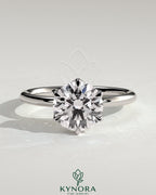 Kynora CJ 2ct round claw solitaire engagement ring with petal gallery design, featuring a sparkling central diamond and intricate band.