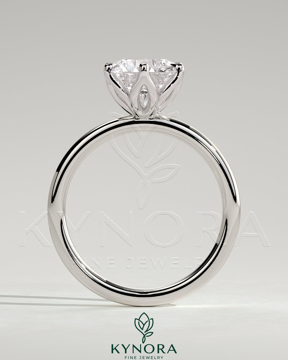 Kynora CJ 2ct round claw solitaire engagement ring with petal gallery design in polished metal setting.