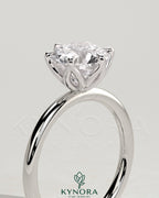 Kynora CJ 2-carat round claw solitaire engagement ring with petal gallery design, featuring a sparkling central diamond.