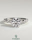Kynora CJ 2ct round claw solitaire engagement ring with round-marquise bezel accent stones in a sleek design.