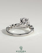 Kynora CJ 2ct round claw solitaire engagement ring with round and marquise bezel accent stones, elegant and sparkling jewelry piece