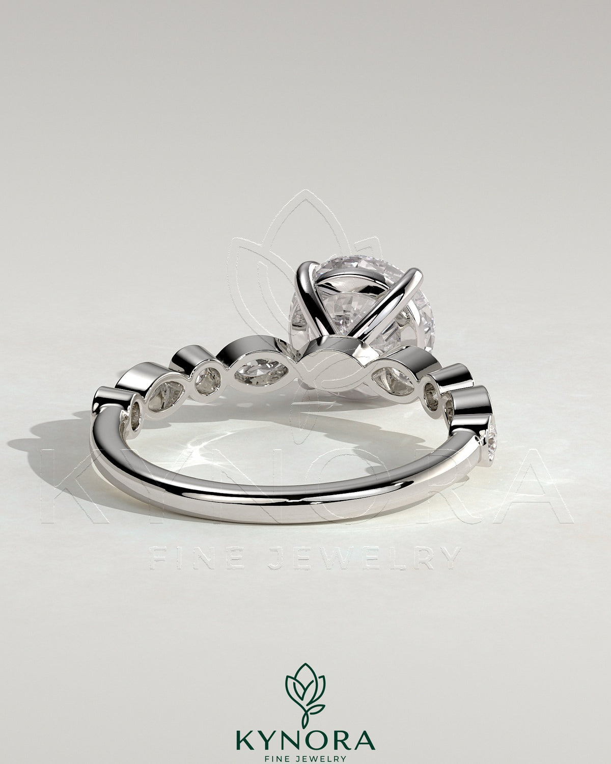 Kynora CJ 2ct round claw solitaire engagement ring with round and marquise bezel accent stones, elegant and sparkling jewelry piece