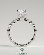 Kynora CJ 2ct round claw solitaire engagement ring with round-marquise bezel accent stones, showcasing sparkling diamond design.