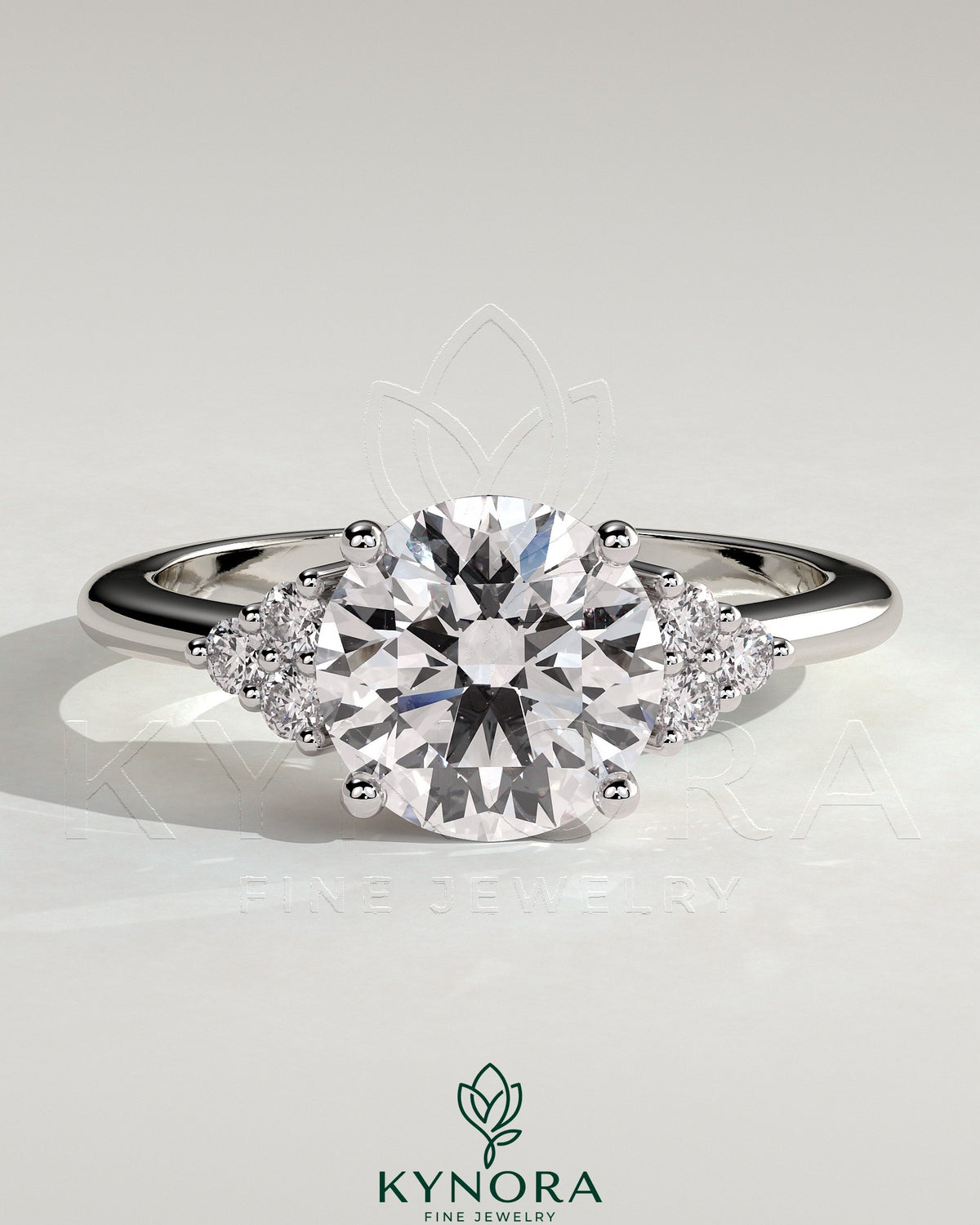 Kynora CJ 2ct round claw solitaire engagement ring with round shoulder stones, showcasing elegant diamond setting and band details.