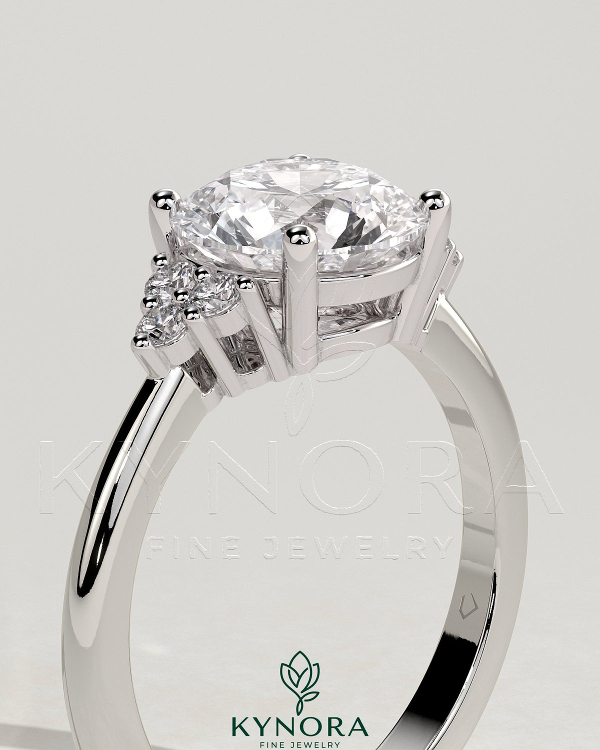 Kynora CJ 2ct round claw solitaire engagement ring with round shoulder stones, crafted in elegant jewelry design.